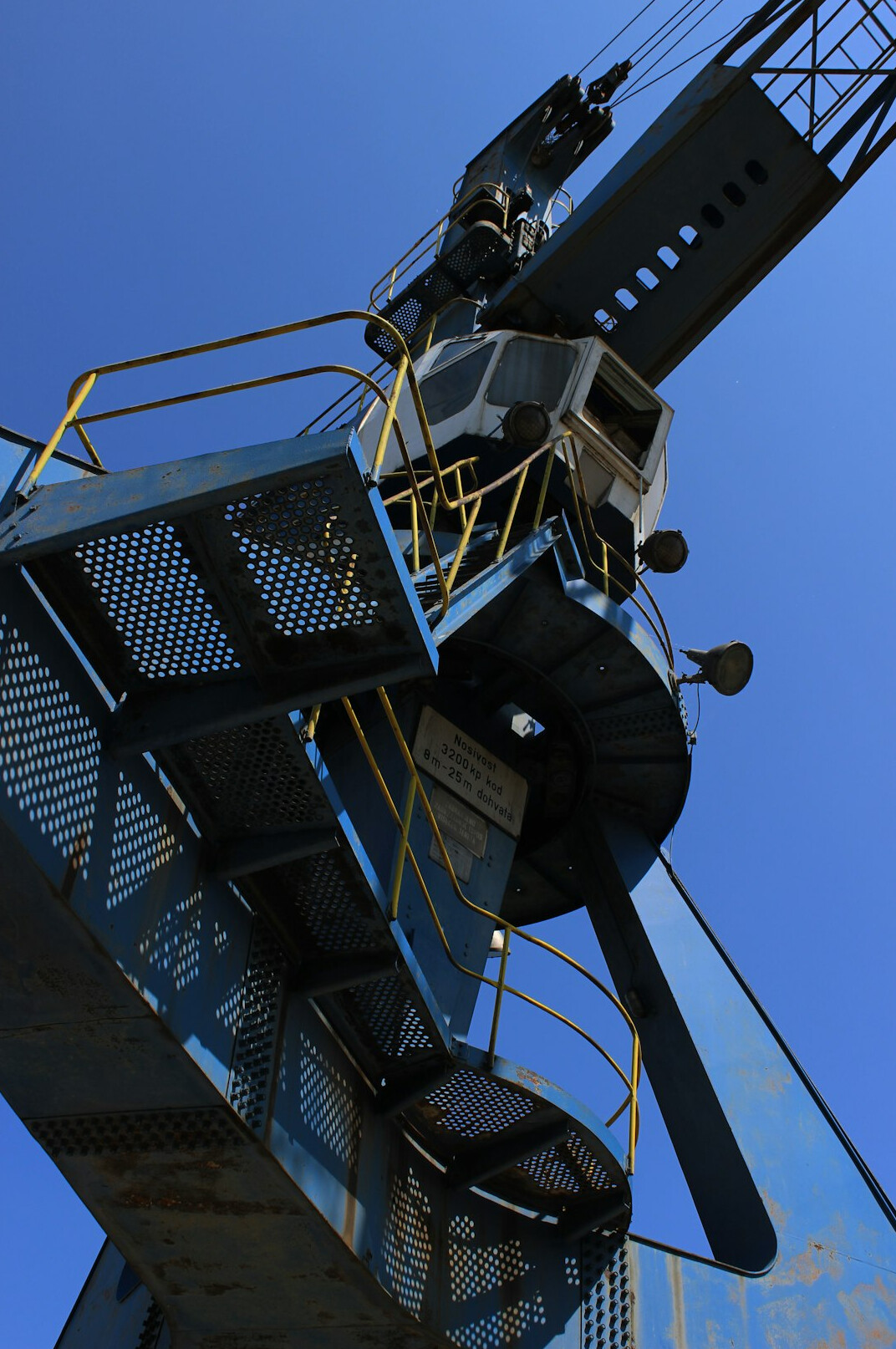 Camera jib arm swinging over a studio set